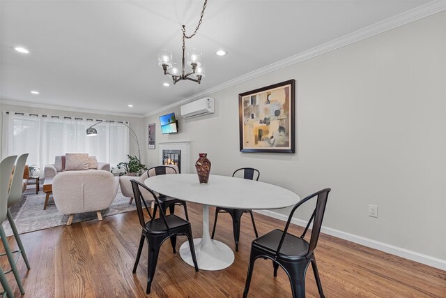 112 Edgehill Dr, Wappingers Falls, NY 12590 - dining space featuring ornamental molding, an AC wall unit, a glass covered fireplace, baseboards, and wood finished floors