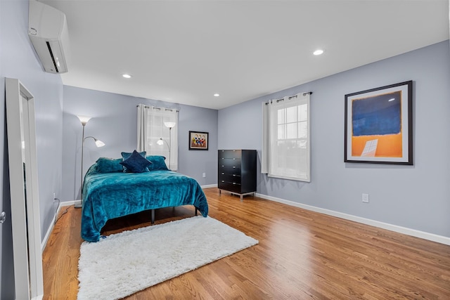112 Edgehill Dr, Wappingers Falls, NY 12590 - bedroom with a wall mounted air conditioner, wood finished floors, baseboards, and recessed lighting