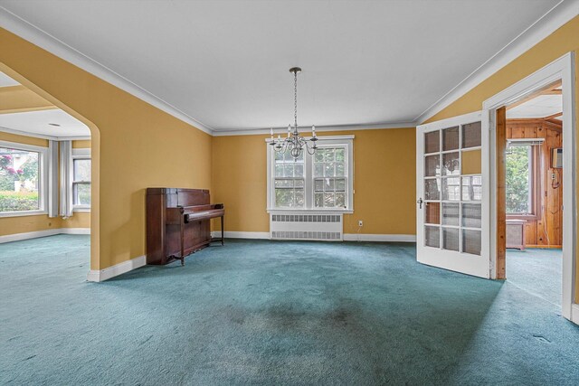 unfurnished dining area with radiator, carpet flooring, plenty of natural light, and ornamental molding