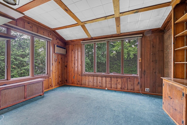unfurnished room featuring radiator, plenty of natural light, baseboards, carpet flooring, and wooden walls