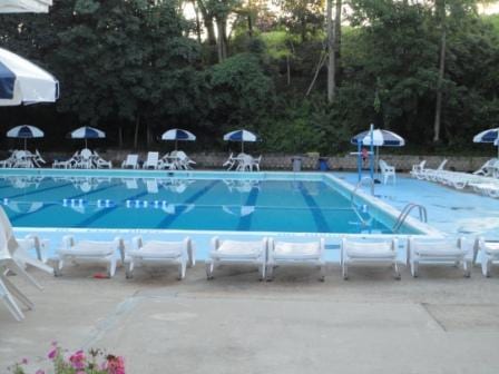 2 Sadore Ln Unit 5U, Yonkers, NY 10710 - community pool featuring a patio area