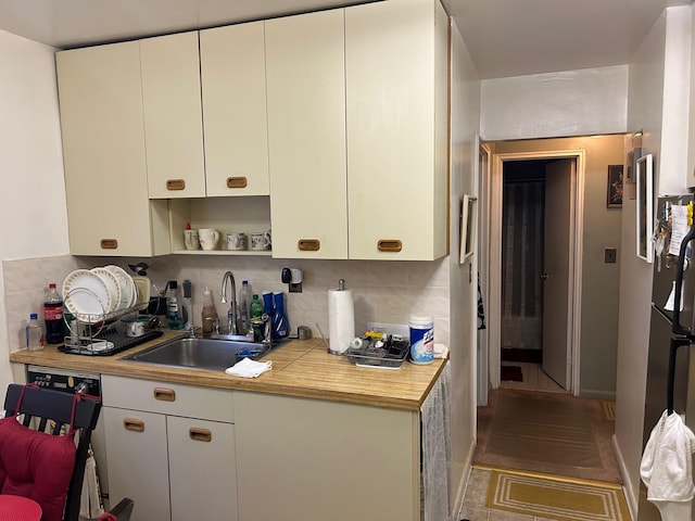 2 Sadore Ln Unit 5U, Yonkers, NY 10710 - kitchen featuring decorative backsplash, white cabinetry, and open shelves