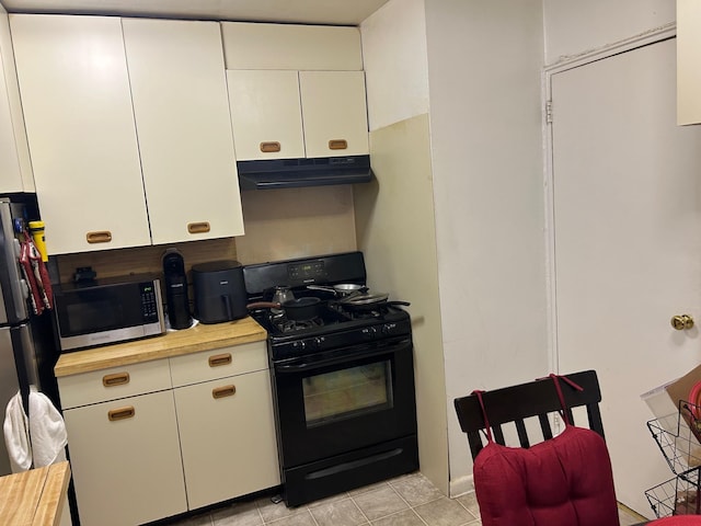 2 Sadore Ln Unit 5U, Yonkers, NY 10710 - kitchen with appliances with stainless steel finishes, under cabinet range hood, white cabinets, and light tile patterned floors
