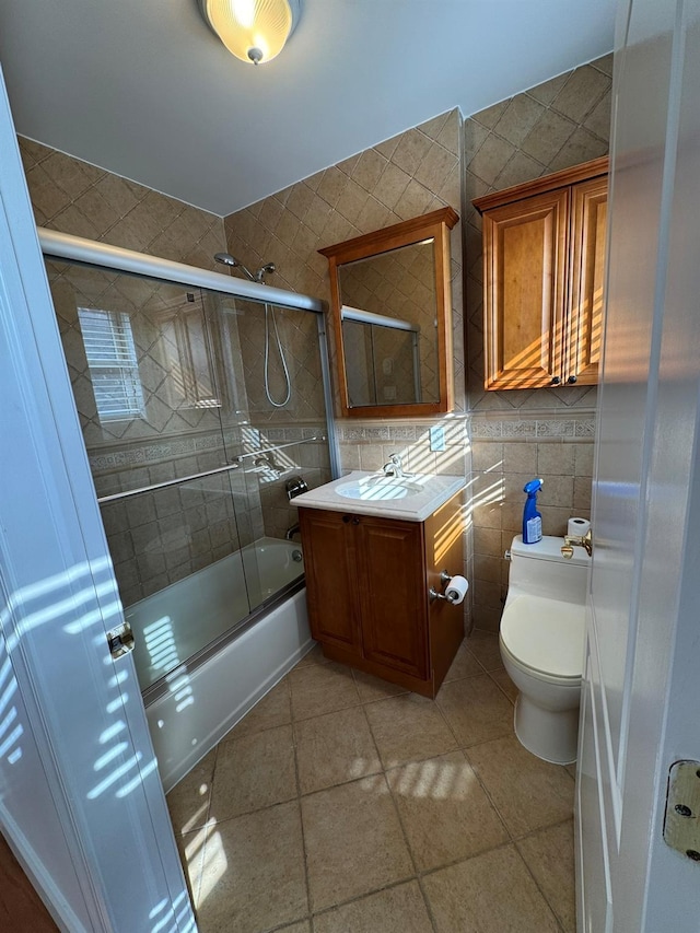 42-23 212th St Unit 3C, Bayside, NY 11361 - bathroom with tile patterned floors, tile walls, toilet, bath / shower combo with glass door, and vanity