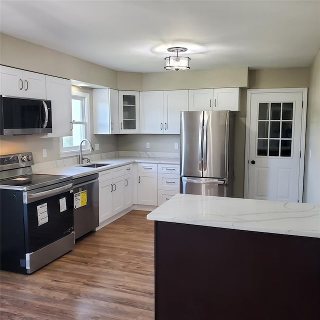 111 Cream St, Poughkeepsie, NY 12601 - kitchen with appliances with stainless steel finishes, a sink, white cabinets, light stone counters, and wood finished floors