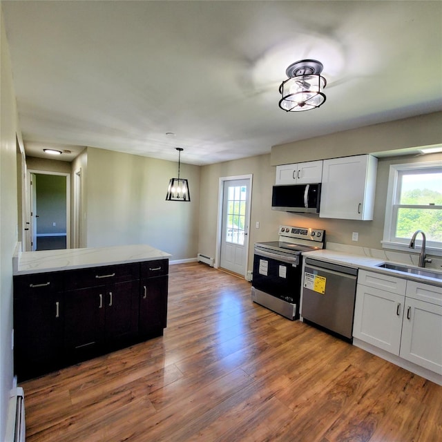 111 Cream St, Poughkeepsie, NY 12601 - kitchen featuring appliances with stainless steel finishes, a sink, baseboard heating, a baseboard heating unit, and plenty of natural light