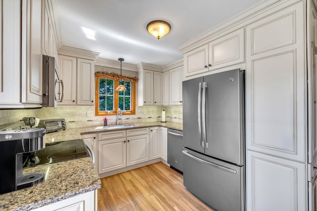 22 Witte Dr, Middletown, NY 10940 - kitchen with stainless steel appliances, a sink, light wood-type flooring, tasteful backsplash, and light stone counters