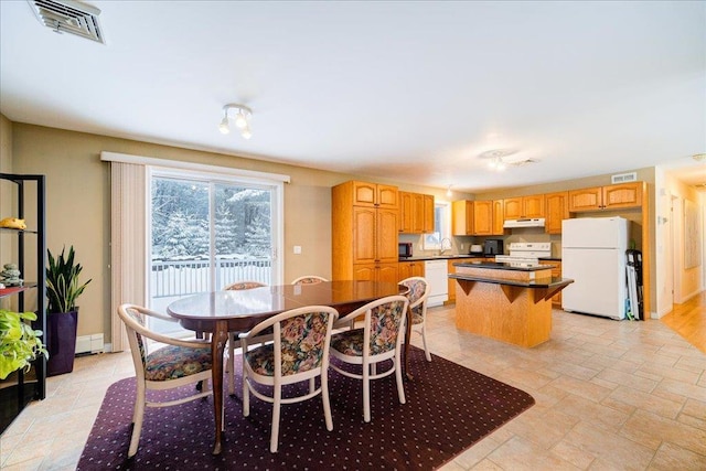 236 Budd Rd, Wurtsboro, NY 12788 - dining room with a baseboard heating unit and light stone finish floors