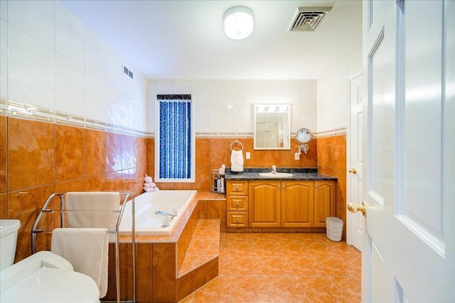 236 Budd Rd, Wurtsboro, NY 12788 - full bathroom with toilet, tile walls, a bath, vanity, and tile patterned floors
