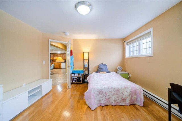 236 Budd Rd, Wurtsboro, NY 12788 - bedroom with a baseboard heating unit and wood finished floors