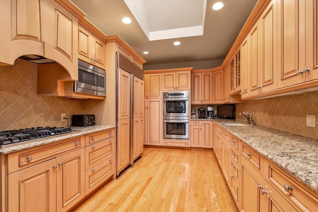 1314 Everit Pl, Hewlett Harbor, NY 11557 - kitchen with appliances with stainless steel finishes, a sink, recessed lighting, backsplash, and light wood finished floors