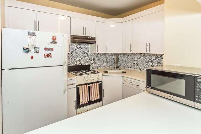 35-20 Leverich St Unit B 227, Jackson Heights, NY 11372 - kitchen featuring white appliances, under cabinet range hood, a sink, light countertops, and backsplash