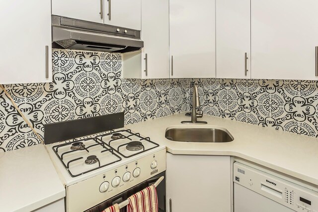 35-20 Leverich St Unit B 227, Jackson Heights, NY 11372 - kitchen featuring white appliances, under cabinet range hood, a sink, light countertops, and white cabinetry