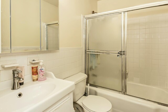 35-20 Leverich St Unit B 227, Jackson Heights, NY 11372 - full bath with toilet, combined bath / shower with glass door, tile walls, and vanity