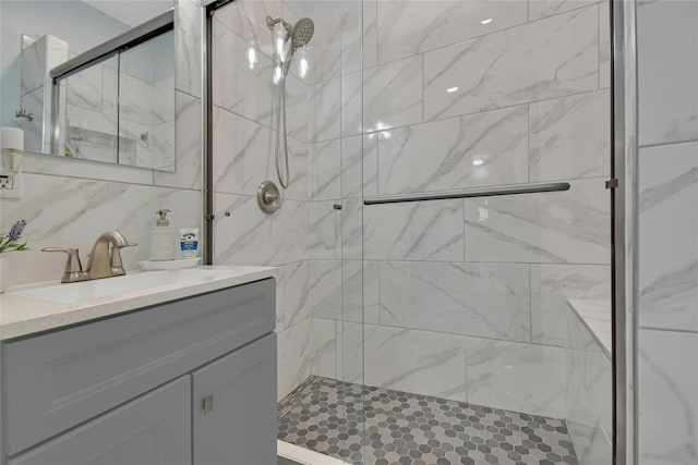 bathroom featuring a stall shower and vanity