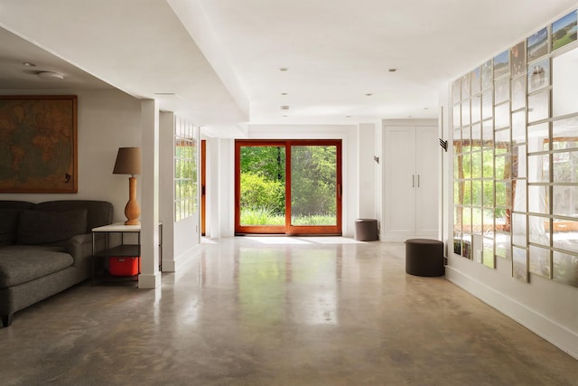 living room featuring finished concrete floors and baseboards