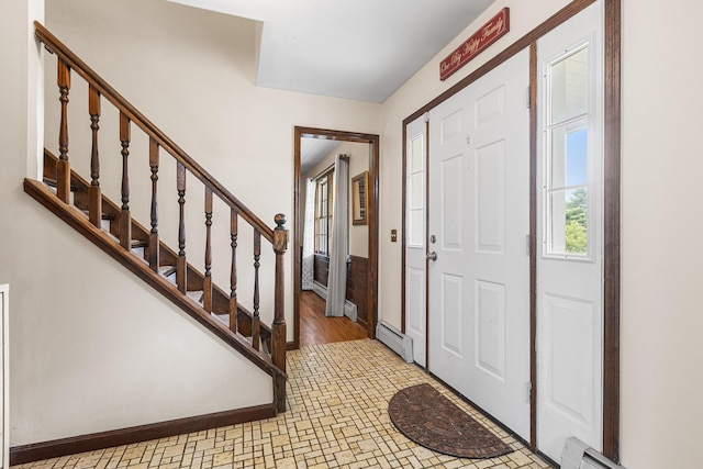 entryway with a baseboard radiator and stairway