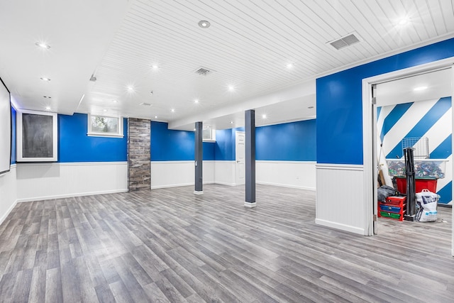 below grade area with a wainscoted wall, wood finished floors, wooden ceiling, and recessed lighting