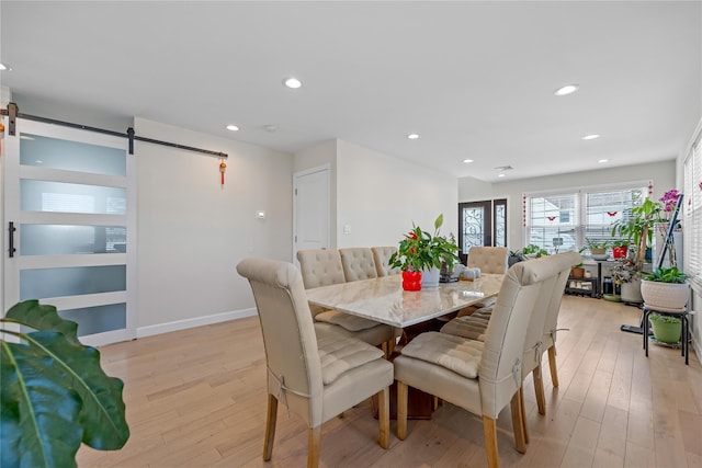 3875 S St, Seaford, NY 11783 - dining room with a barn door, light wood-style flooring, recessed lighting, and baseboards