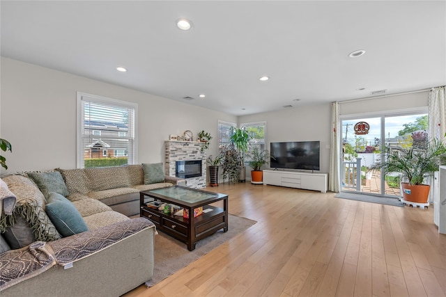 3875 S St, Seaford, NY 11783 - living room with a glass covered fireplace, recessed lighting, and light wood-type flooring