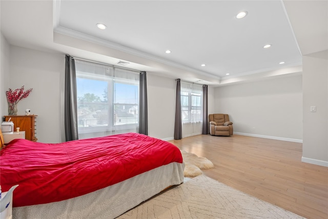3875 S St, Seaford, NY 11783 - bedroom featuring a tray ceiling, crown molding, light wood-style flooring, recessed lighting, and baseboards