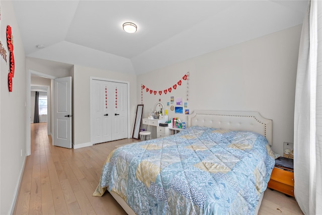 3875 S St, Seaford, NY 11783 - bedroom with light wood finished floors, baseboards, a tray ceiling, and a closet