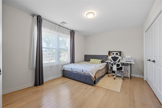 3875 S St, Seaford, NY 11783 - bedroom featuring baseboards, a closet, and light wood-type flooring