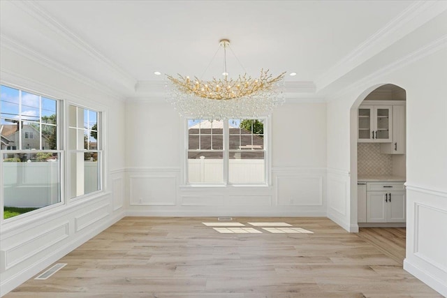 42 Second St, Extension, Glen Cove, NY 11542 - unfurnished dining area with a chandelier, light wood-style floors, a decorative wall, ornamental molding, and a wainscoted wall