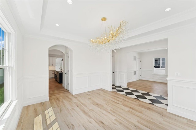 42 Second St, Extension, Glen Cove, NY 11542 - unfurnished dining area with a decorative wall, arched walkways, light wood-style floors, a wainscoted wall, and recessed lighting