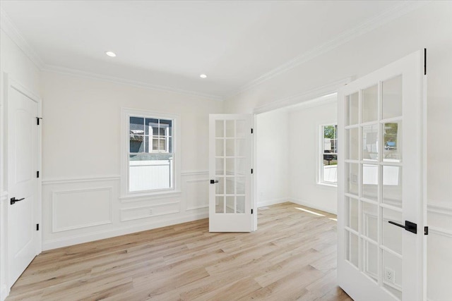 42 Second St, Extension, Glen Cove, NY 11542 - spare room with french doors, light wood finished floors, healthy amount of natural light, ornamental molding, and wainscoting