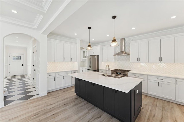 42 Second St, Extension, Glen Cove, NY 11542 - kitchen featuring wall chimney range hood, stainless steel appliances, a sink, white cabinetry, and arched walkways