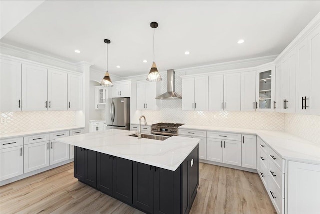 42 Second St, Extension, Glen Cove, NY 11542 - kitchen featuring a sink, stainless steel appliances, wall chimney range hood, white cabinets, and light wood finished floors