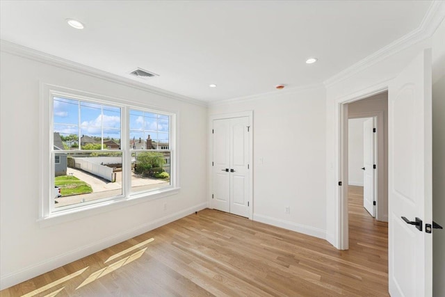 42 Second St, Extension, Glen Cove, NY 11542 - unfurnished bedroom featuring crown molding, baseboards, light wood finished floors, recessed lighting, and a closet