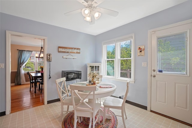 dining space with baseboards, healthy amount of natural light, and a ceiling fan
