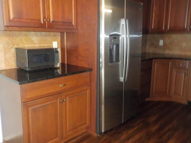 808 Woodland Ct, Coram, NY 11727 - kitchen with stainless steel appliances, tasteful backsplash, dark stone counters, brown cabinets, and dark wood-type flooring