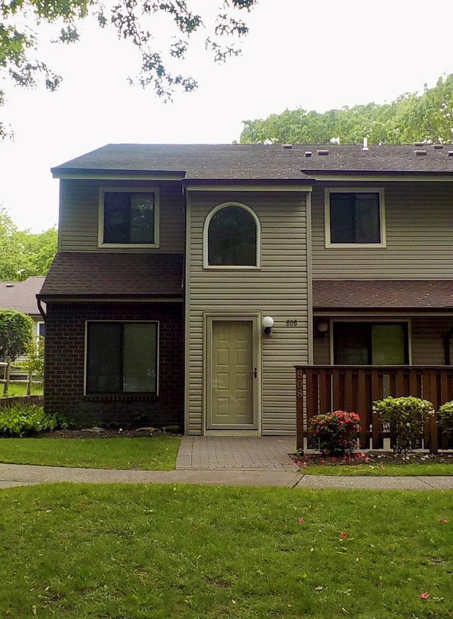 808 Woodland Ct, Coram, NY 11727 - view of front facade featuring a front yard, a shingled roof, and brick siding