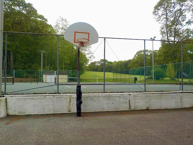 808 Woodland Ct, Coram, NY 11727 - view of sport court featuring community basketball court and fence
