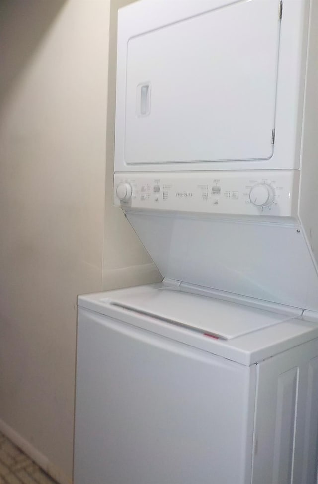 808 Woodland Ct, Coram, NY 11727 - washroom featuring stacked washer and clothes dryer