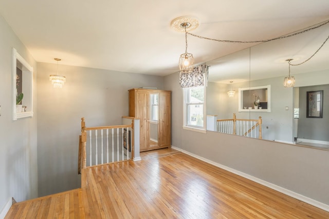 251-12 71st Rd Unit 29B, Bellerose, NY 11426 - unfurnished room featuring hardwood / wood-style floors, baseboards, and a chandelier