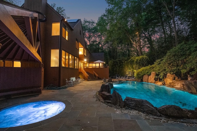 5 Ponds Ln, Purchase, NY 10577 - pool at dusk with stairs, a patio, an outdoor pool, and a deck
