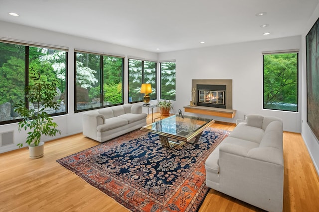 5 Ponds Ln, Purchase, NY 10577 - living area featuring plenty of natural light, wood finished floors, a glass covered fireplace, and recessed lighting