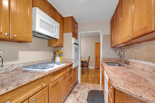 209-25 18th Ave Unit 3J, Bayside, NY 11360 - kitchen featuring white appliances, a sink, a warming drawer, brown cabinetry, and light stone countertops
