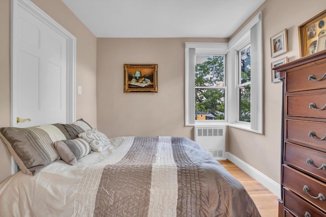 209-25 18th Ave Unit 3J, Bayside, NY 11360 - bedroom featuring radiator, light wood-type flooring, and baseboards