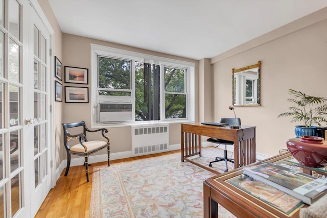 209-25 18th Ave Unit 3J, Bayside, NY 11360 - office space featuring radiator heating unit, cooling unit, baseboards, wood finished floors, and french doors