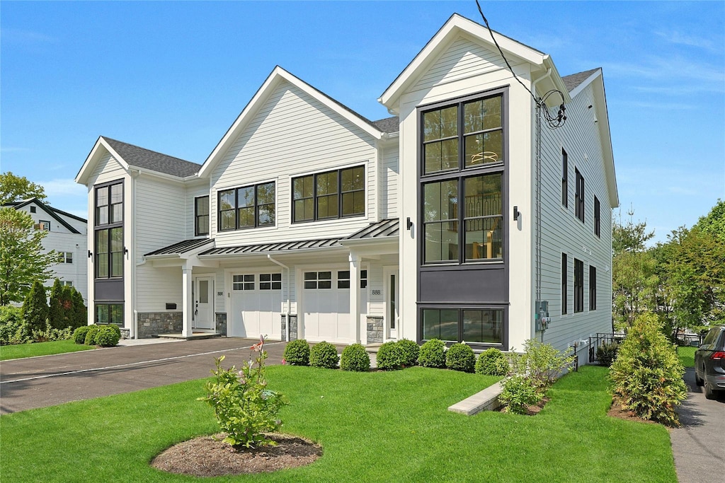 88 Orchard Ave Unit B, Rye, NY 10580 - view of front facade with a standing seam roof, an attached garage, a front lawn, driveway, and metal roof