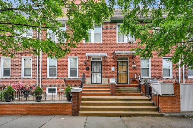 25-66 46th St, Astoria, NY 11103 - view of property with a fenced front yard and brick siding