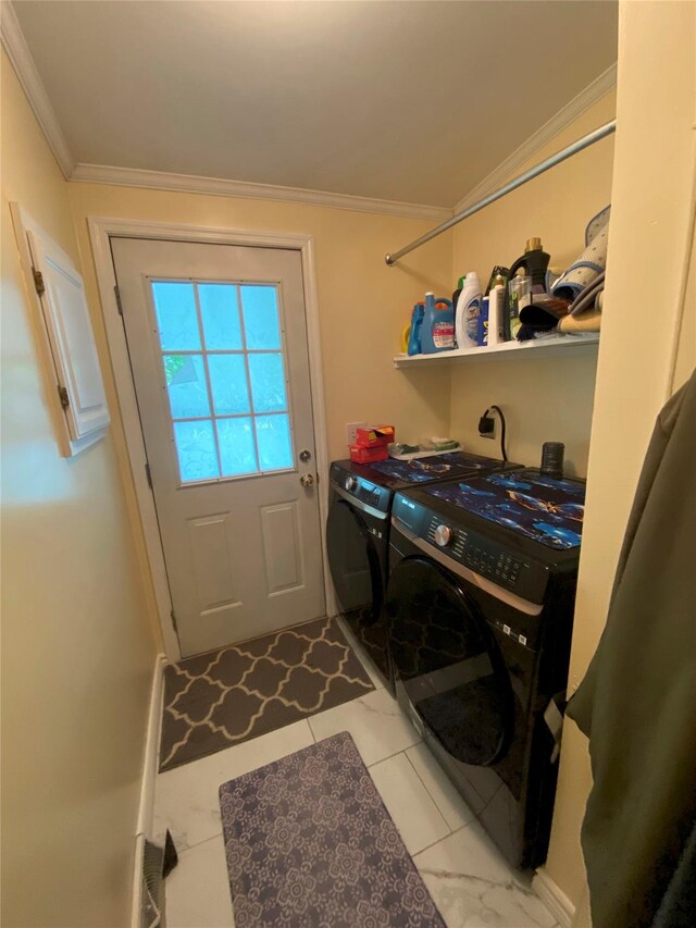 clothes washing area featuring washing machine and dryer and ornamental molding