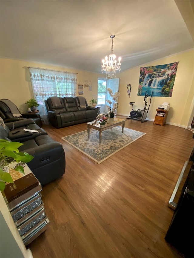 living area featuring a chandelier, wood finished floors, and baseboards