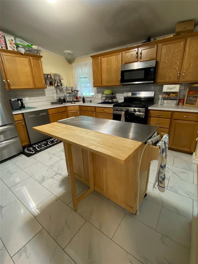 kitchen with appliances with stainless steel finishes, light marble finish flooring, butcher block countertops, decorative backsplash, and brown cabinetry
