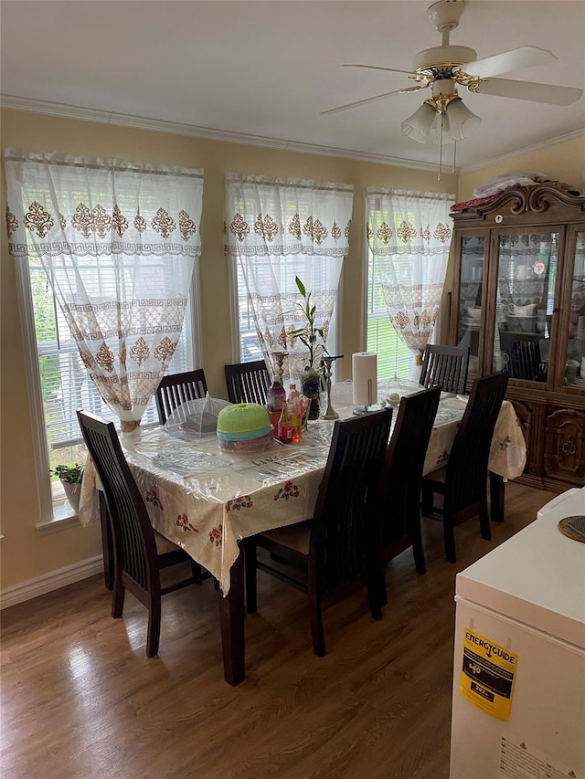 dining space featuring plenty of natural light, a ceiling fan, crown molding, and wood finished floors